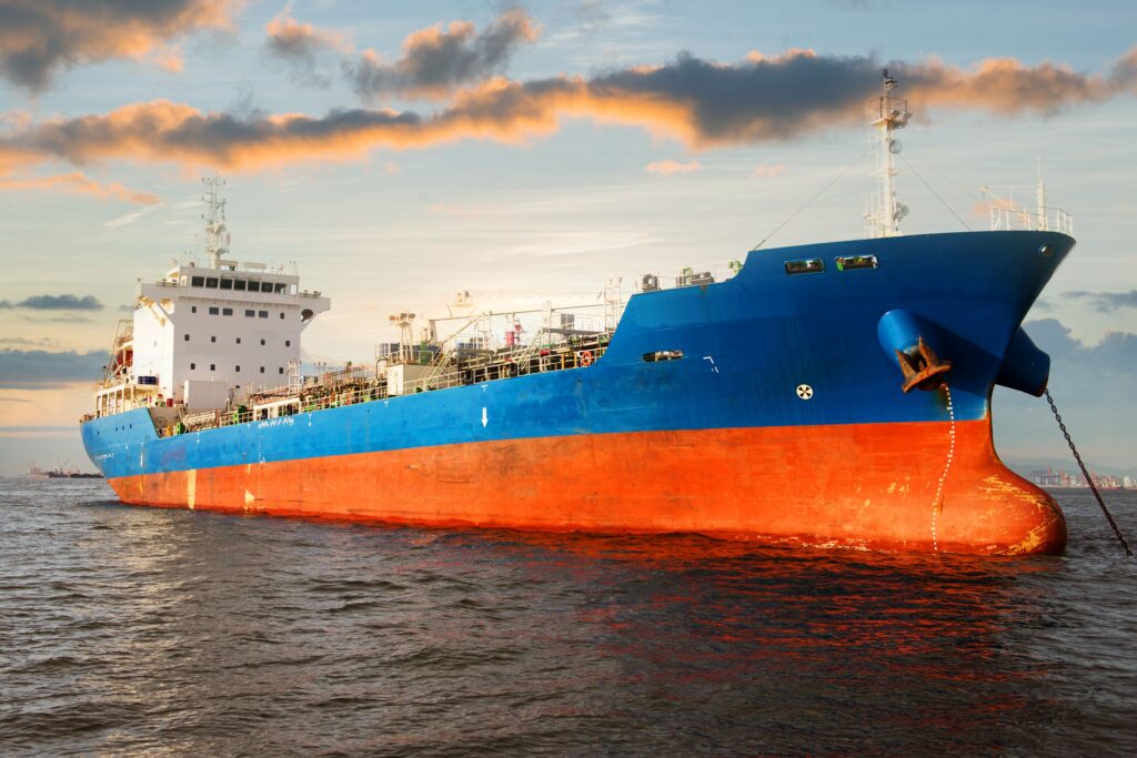 Chemical tanker ship is anchored at sea after discharging cargo operation mid-stream with beautiful sky.