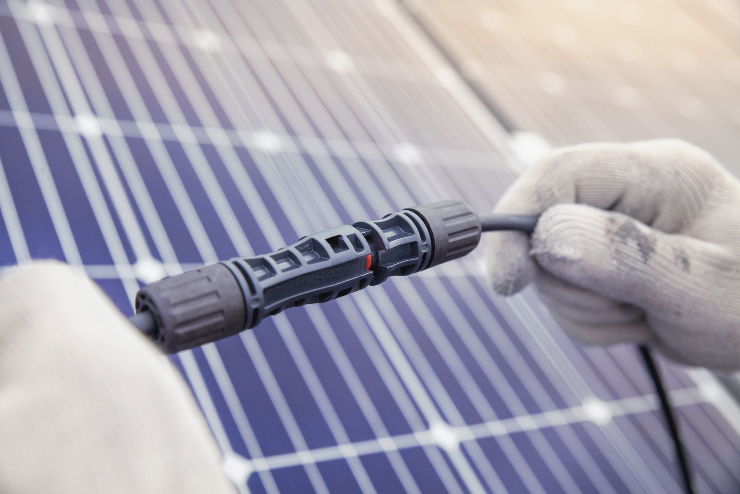 Technician Connecting the electric wire from solar panels genera